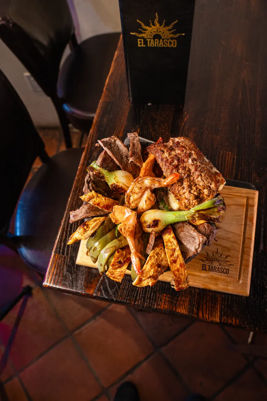 The molcajete plated on its branded wood board in the dining room